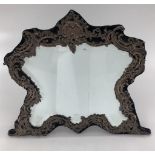A large sterling silver mounted shield shaped easel backed dressing table mirror, by William Comyns,