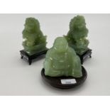 Pair of C20th Jade dogs of fo on hardwood stands, and a jade buddha on circular stand