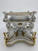 Large gilt and bisque Minton style table centre piece with mythical beasts and putti supports,