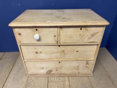 A pine chest of 2 short over 2 long drawers with white knob handles