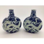 Pair of C20th blue and white Moonflask vases, decorated dragons to body