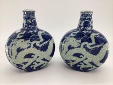 Pair of C20th blue and white Moonflask vases, decorated dragons to body