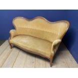 French, C19th walnut framed sofa, with shaped back, and legs, and gold coloured upholstery. With