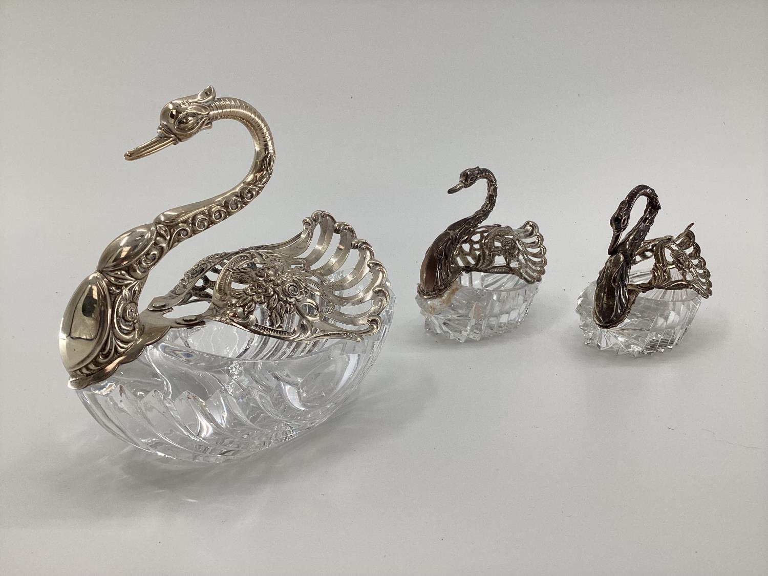 Three silver and moulded glass swan shaped table pot pouris, stamped 800 and 925, largest 15 x 17