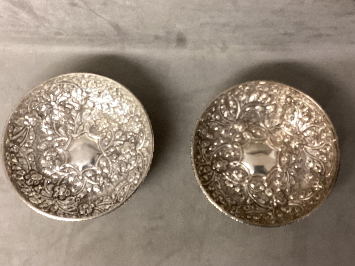 Pair of Middle Eastern white metal bowls with raised floral decoration raised on three feet, 14 x - Image 2 of 5