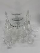 Quantity of glass including modern cake platters on stands, cut glass decanters, wine glasses,