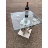 A contemporary and decorative glass occasional table, with marble base of four sconces and a central