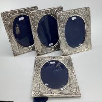 Set of 4 Turkish silver easel backed picture frames with chased and raised floral design and oval