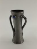Liberty & CO Tudric twist handled vase, set with 2 blue glass cabochons, by Oliver Baker, marked