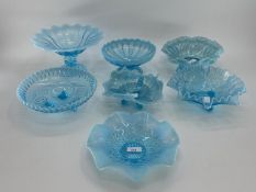 A collection of blue Vaseline/opaline glass items to include footed glass bowls (7)