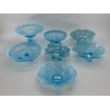 A collection of blue Vaseline/opaline glass items to include footed glass bowls (7)