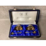 Boxed pair of sterling silver salts and spoons of shell design by Mappin & Webb, London