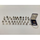 Large collection of mainly sterling silver and unmarked white metal thimbles, various makers and