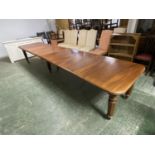 A mahogany square dining table, extending to an oblong metres table, with the extra leaves. Being