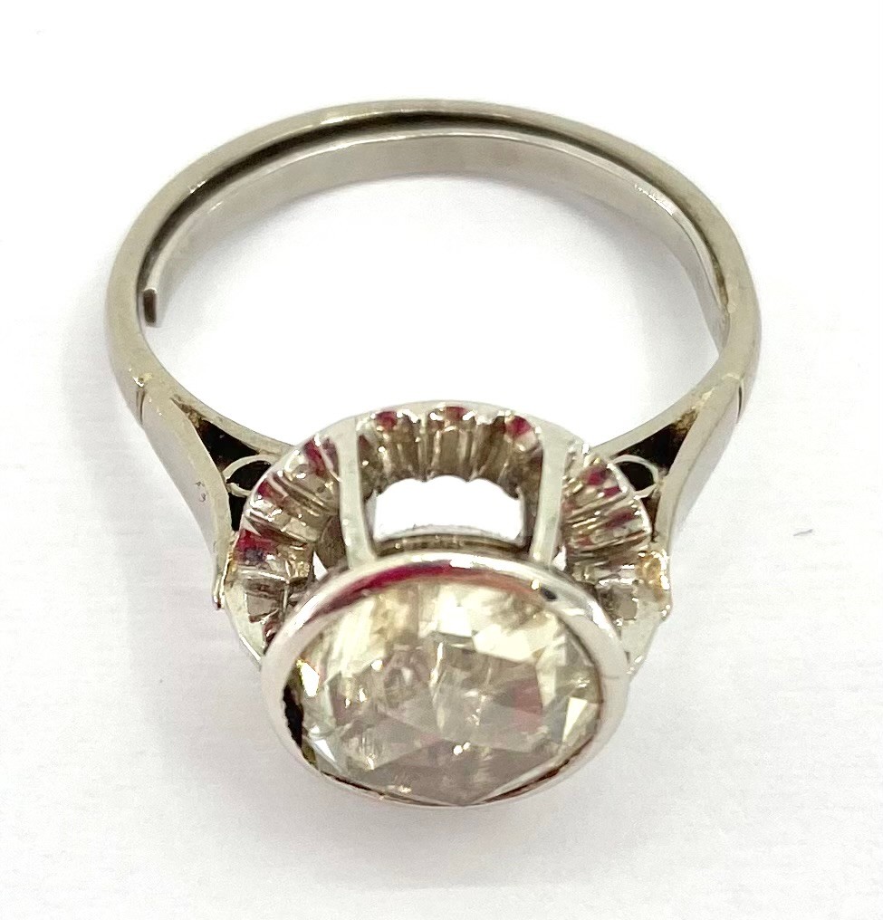 Continental platinum and diamond single stone ring, in pierced halo setting, single rose cut