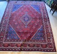 A good large red ground Persian style rug, some wear with use. measures