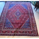 A good large red ground Persian style rug, some wear with use. measures