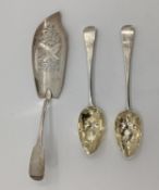 A sterling silver fish slice and two Georgian desert spoons with later applied fruit and berry