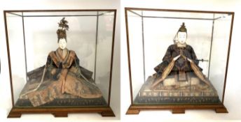 A pair of early and large Japanese Hina Ningyo seated, possibly 18th century in glazed cases;