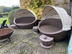 GARDEN FURNITURE: a pair of large semi circular garden sofas, with brown striped cushions, and
