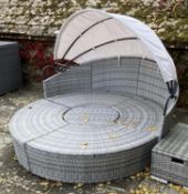 GARDEN FURNITURE: Two similar grey faux rattan/all weather semi circular garden sun sofas and