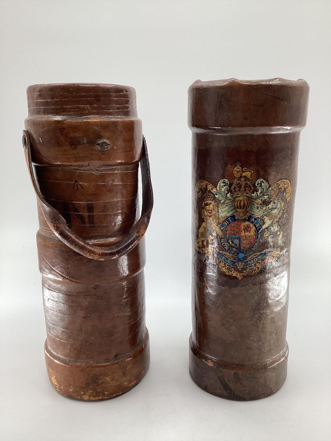 TWO WW1 leather artillery shell carriers, one with military crest, one with carrying handle, both as