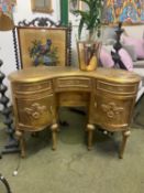 A ladies gilt painted small kidney shaped dressing table, 104cmL