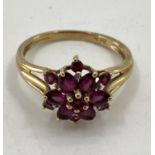 A 9ct gold garnet set flower ring, 3.27g, size R