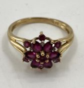 A 9ct gold garnet set flower ring, 3.27g, size R