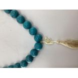 A large faux turquoise bead necklace