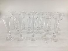 William Yeoward 12 champagne glasses, (and 4 further glasses with chip);