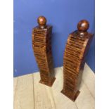 Pair of contemporary wooden pillars set with CD holders, and circular ball finials