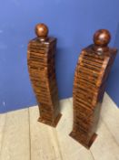 Pair of contemporary wooden pillars set with CD holders, and circular ball finials