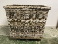 A large old wicker log/linen basket, raised on wheels, as found, 87H x 66D x 86W cm