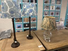 A pair of tall lamps with blue and white shades and a glass lamp with OKA pleated shade