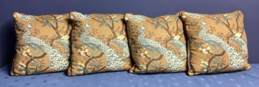 A set of four good cushions, decorated brown ground and blue exotic birds, and cream backs, see