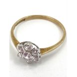 A 9ct gold diamond flower ring set with seven brilliant cut diamonds, 1.1g, size M