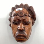A C20th hardwood carving of a native head, believed to be Madagascan, signed verso, J Rasoamanana