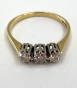 An 18ct gold and diamond three stone ring, 2.69g, size O