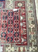 Two Antique rugs, one of red ground with geometric design, 98 x 170; 57 x 100cm