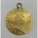 A George III 1788 gold Guinea with soldered loop, 8.27g