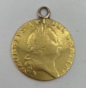 A George III 1788 gold Guinea with soldered loop, 8.27g