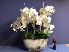 A large impressive faux flowers decorative statement piece, of white orchid arrangements, in large