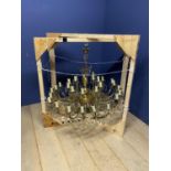 A large gilt metal and glass drop 30 branch double chandelier. Diameter 104cm. Drop 113cm.