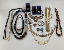 A collection of costume and couture style jewellery to include Christian Dior, Faux amber beads