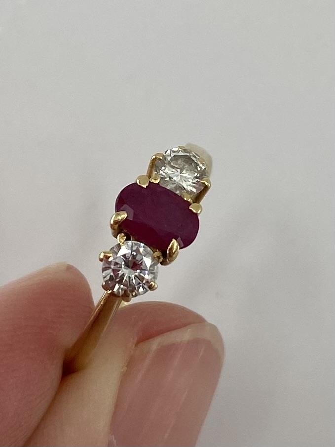 An 18ct gold ruby and diamond ring single oval free cut ruby with brilliant cut diamond accents , - Image 2 of 6