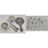 A collection of sterling silver and white metal items to include sugar tongs, pickle fork etc,