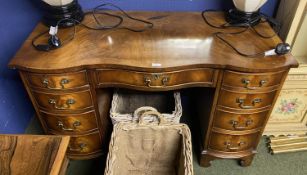 Kidney shaped kneehole desk with central drawer, and 4 drawers to each side, much wear to top