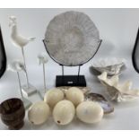 A quantity of decorative items including faux Ostrich eggs, shells, seagull models, fossil type