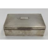 A sterling silver cedar lined cigarette box with engine turned decoration by A J Zimmerman,